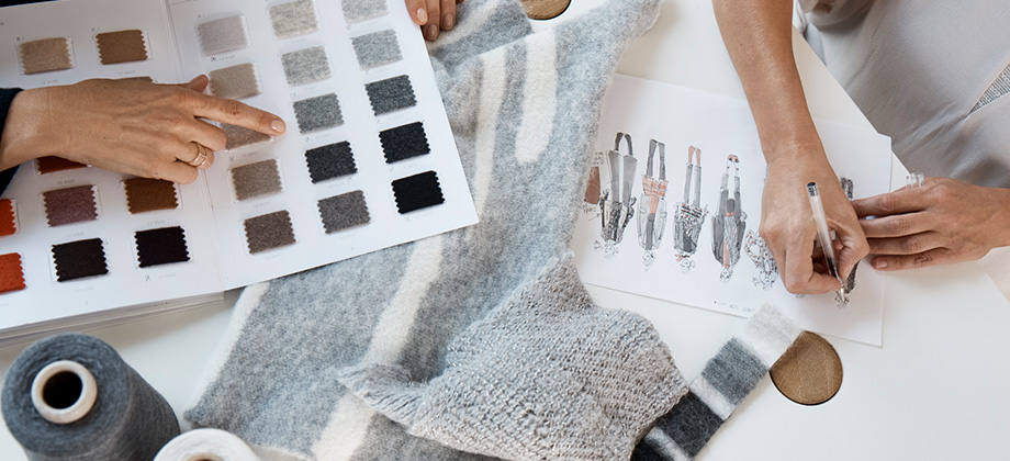 people working on a table with swatches and samples